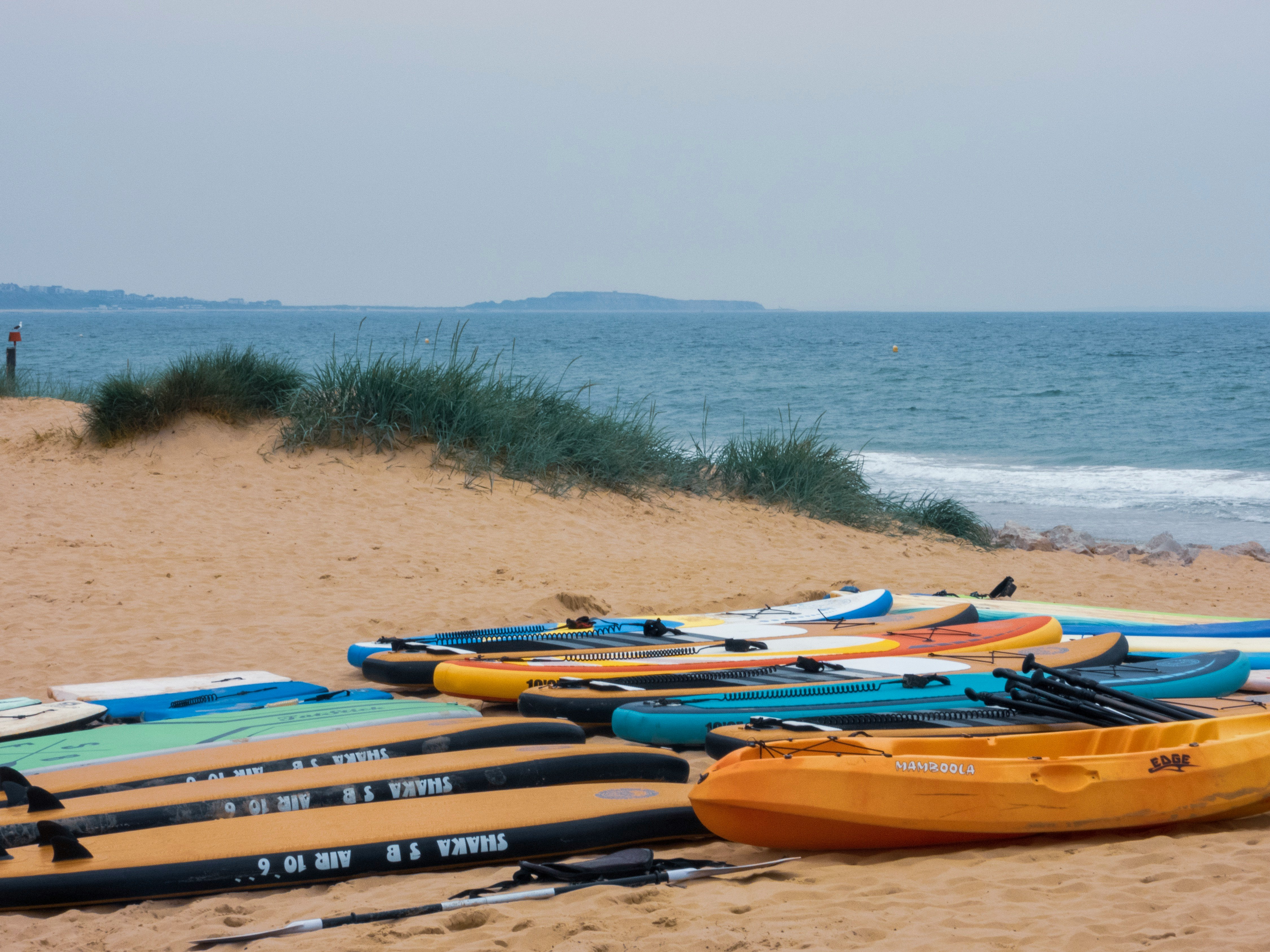 pile of assorted-color kayaks